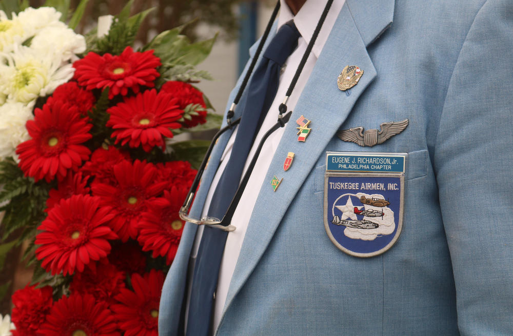 Eugene Richardson, a Tuskegee Airmen in the Philadelphia chapter, stands in front of flowers at the dedication ceremony for the statue of Eugene J. Bullard on Wednesday, Oct. 9, 2019. Bullard was the first African American fighter pilot and fought in the French Armed Forces in World War I.