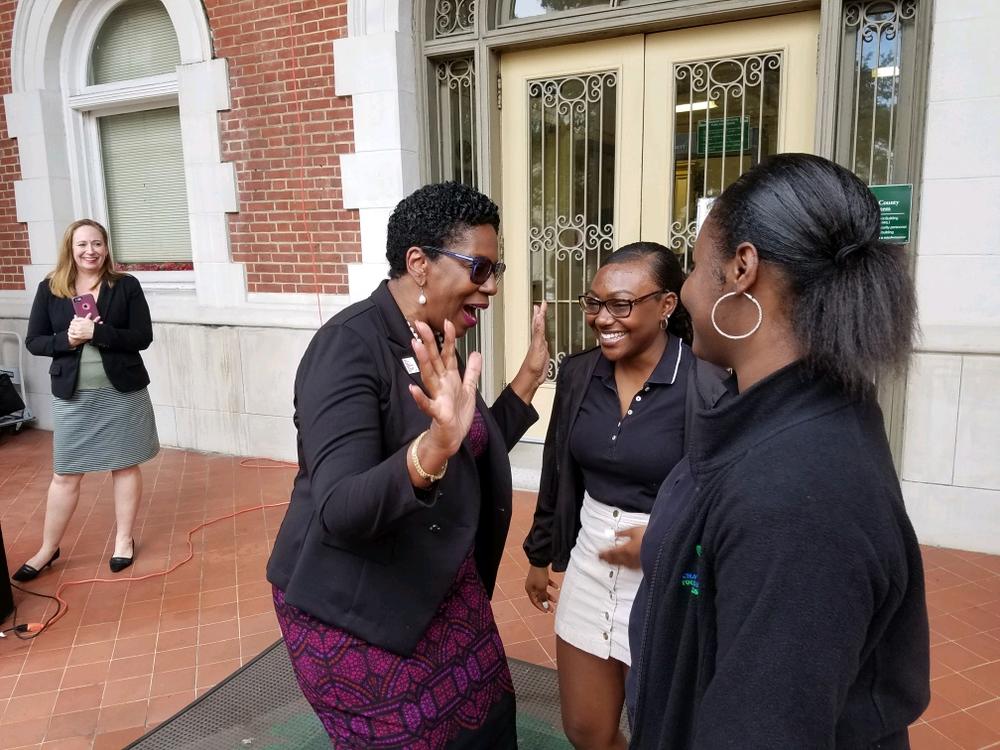 Savannah-Chatham Schools Superintendent Ann Levett talks with Savannah Arts Academy seniors Rishe Williams (center) and A'lani Coppock after announcing the district's partnerhsip to encourage FAFSA completion.