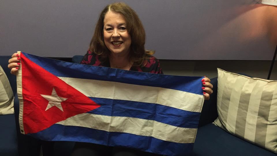 Carmen Bernal holds up the Cuban flag that her mother put on display outside their house the day Fidel Castro rose to power in 1959.