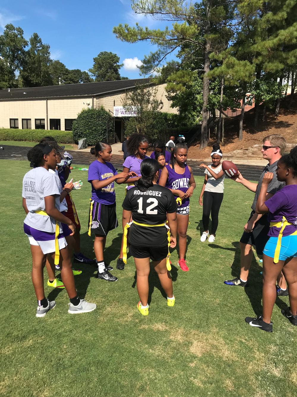 Duluth High School Head Coach Simon Mawson huddles with the team during practice. 