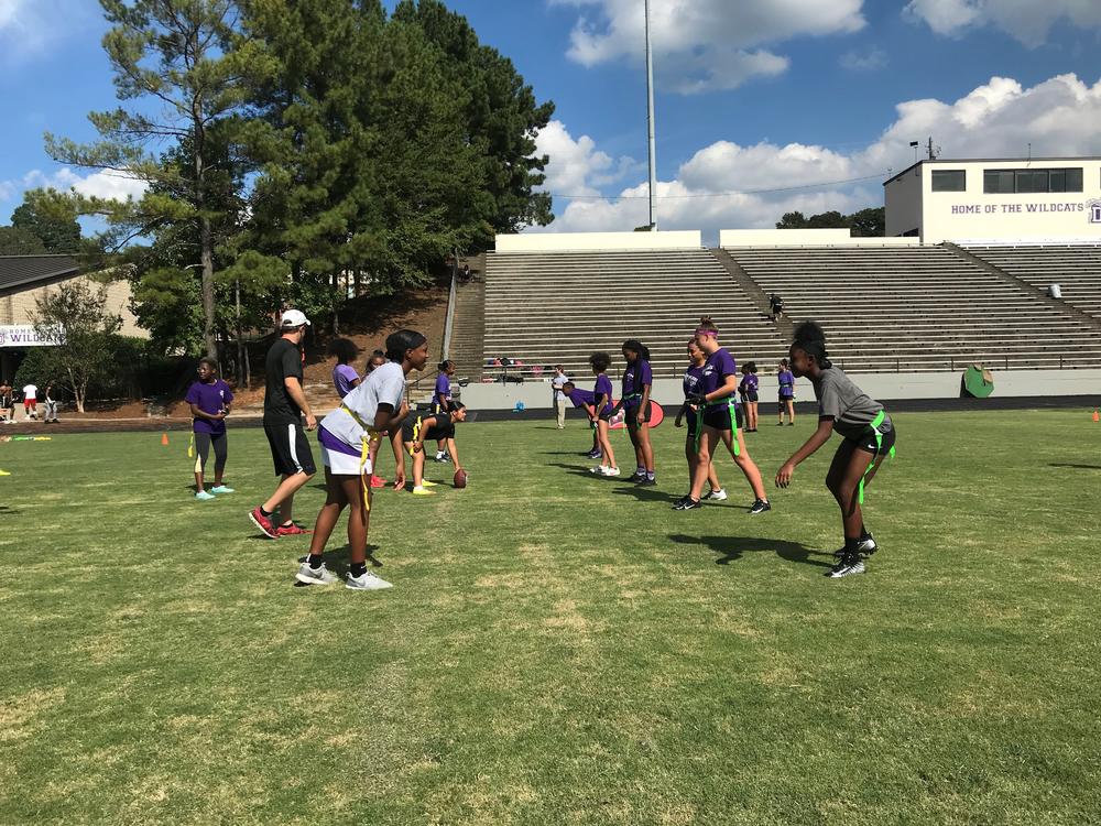 Duluth High School girls get set at the line of scrimmage before running a play in practice. 