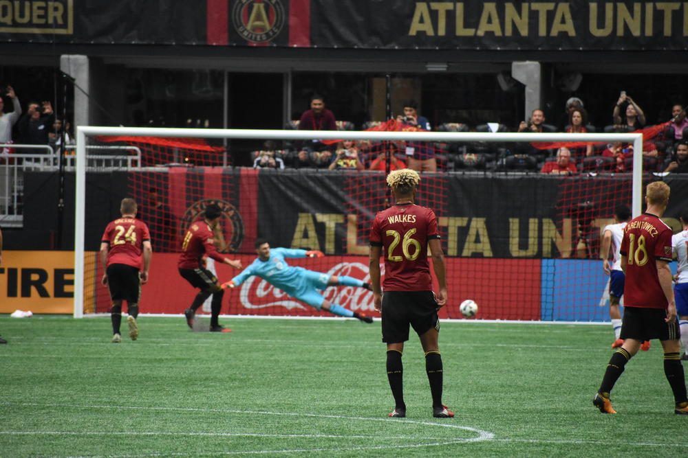 Yamil Asad (11) scores on a penalty kick against Toronto FC as Anton Walkes (26) looks on.