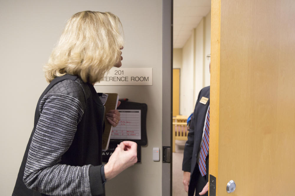 Allison Troxell of Atlanta vents her frustration at the lack of a town hall format for the meeting with representatives of Georgia's two U.S. Senators and on House representative to Greg Ziesenhene of Senator David Perdue's office during an impromptu town hall in Greensboro, Ga. 