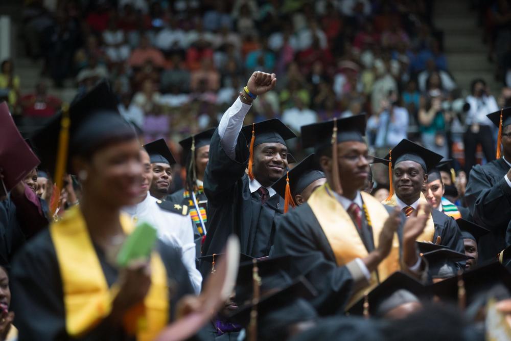 A student in the audience waves during first lady Michelle Obama's remarks for the Tuskegee University Commencement ceremony in Tuskegee, Ala., May 9, 2015