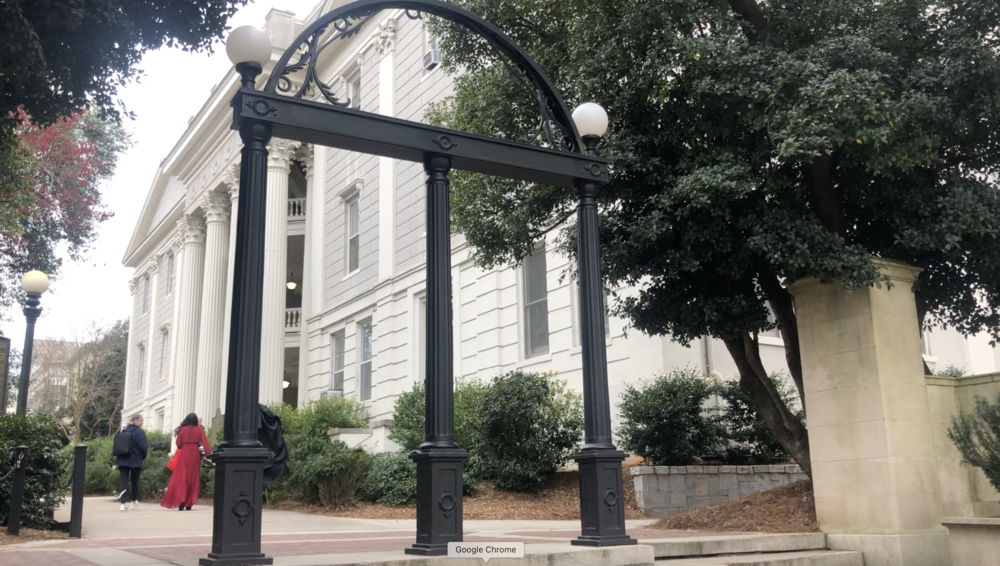 Students walk by the historic arches at the University of Georgia for what might be the last time in weeks due to COVID-19.