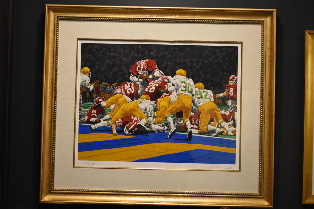 This painting depicts University of Georgia running back Herschel Walker diving into the end zone score at the 1981 Sugar Bowl.