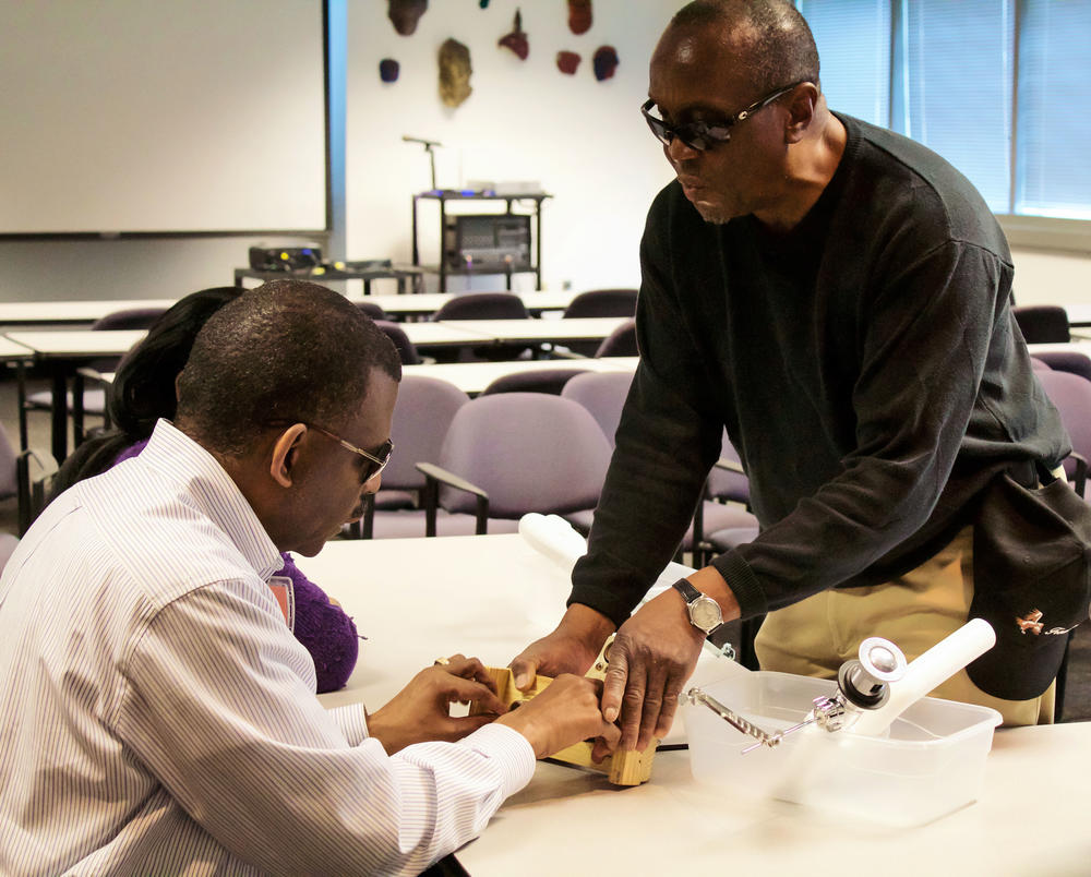 George Acey helping a CVI client.