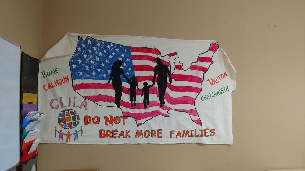 A sign hangs up in the offices of Coalicion de Lideres Latinos in Dalton, Georgia. The group provides support for immigrants in the area.
