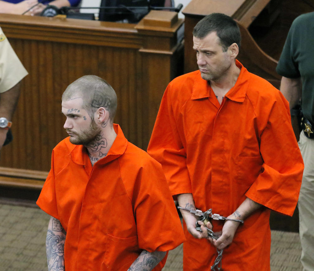 In this June 21, 2017, file photo, Ricky Dubose, left, and Donnie Russell Rowe enter the Putnam County courthouse in Eatonton, Ga.