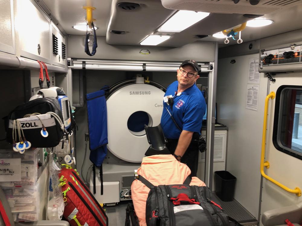 Grady Bagley adjusts the stretcher in the mobile stroke ambulance that runs at Grady Memorial Hospital as part of the Marcus Stroke and Neuroscience Center. 