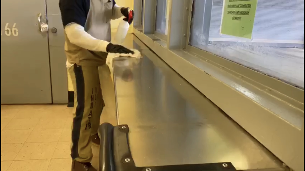 An inmate at Fulton County Jail cleans surfaces to avoid an outbreak of COVID-19.