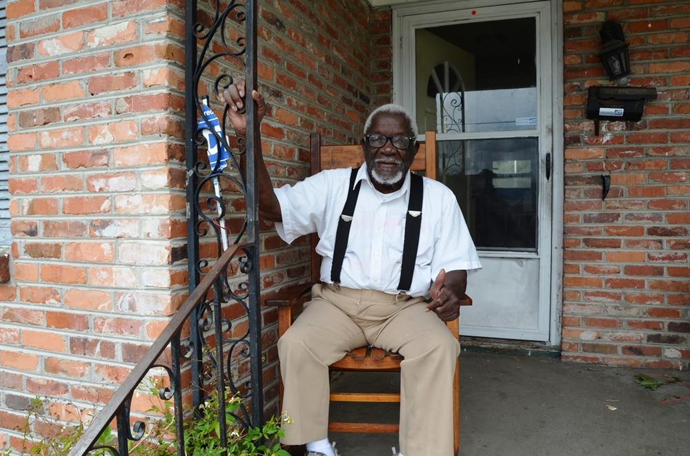 Retired Lieutenant John White sits on his porch in his Savannah home.