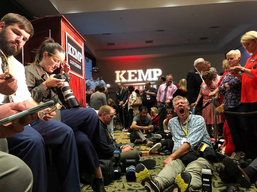 Journalists wait after 2 a.m. to hear Brian Kemp speak to supporters. 