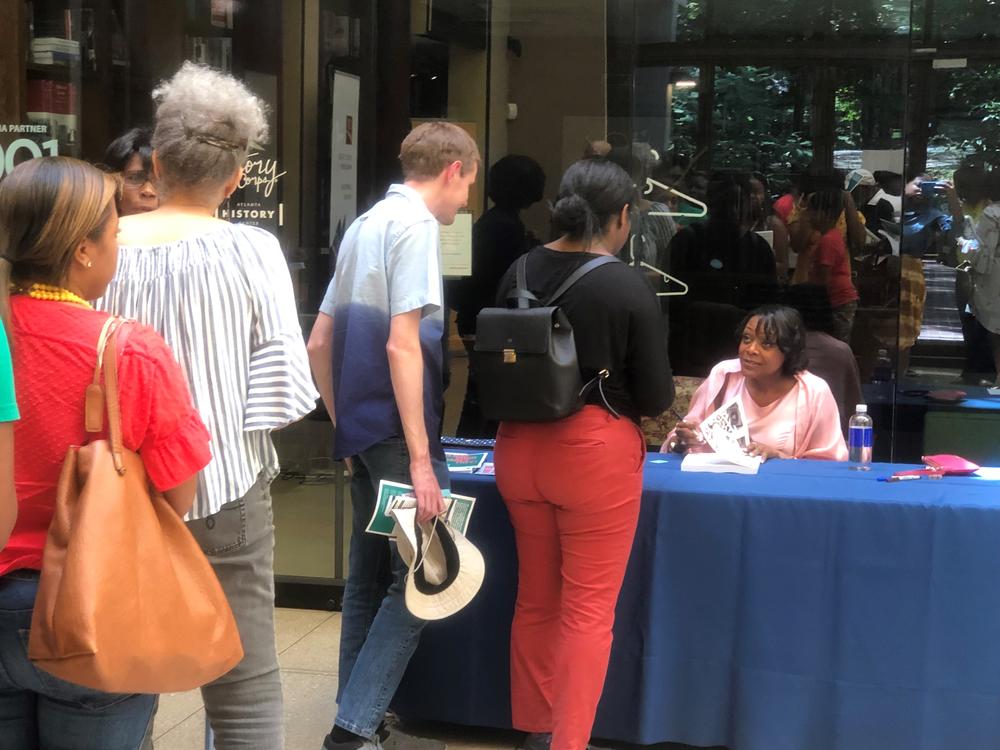 Author and genealogist Kenyatta Berry autographs books at Atlanta History Center for Juneteenth.