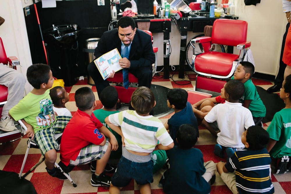 U.S. Education Secretary John King reads to a group of school-aged children. He recently advised governors and state school leaders to do away with corporal punishment.