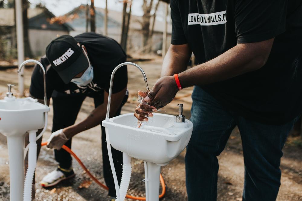Love Beyond Walls volunteers help set up handwashing stations around Atlanta to help people experiencing homelessness protect themselves against the spread of coronavirus.