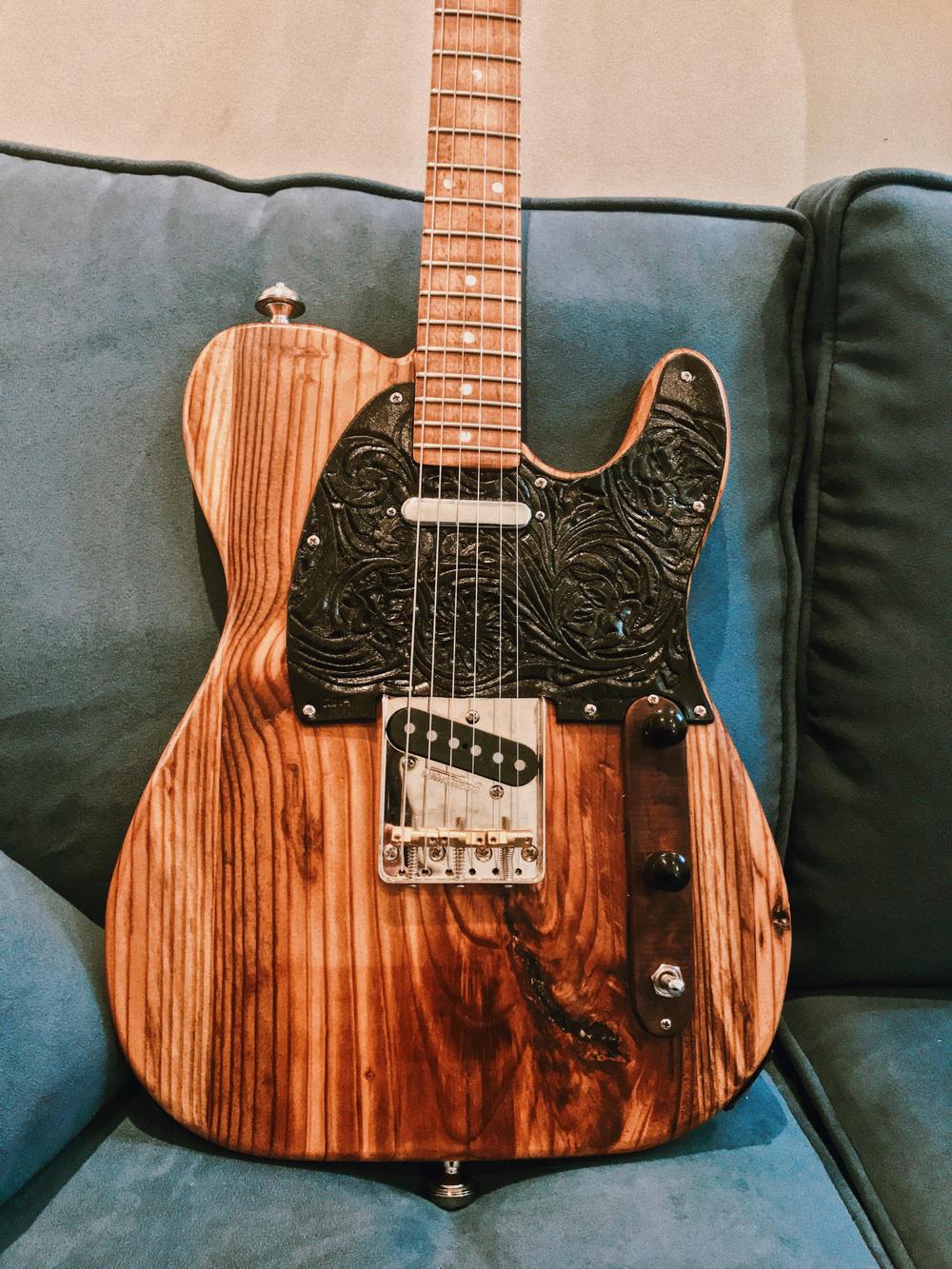 Atlanta musician Maggie Schneider's guitar is made from the wood of the Excelsior Mill in downtown Atlanta, former home of the Masquerade music venue.