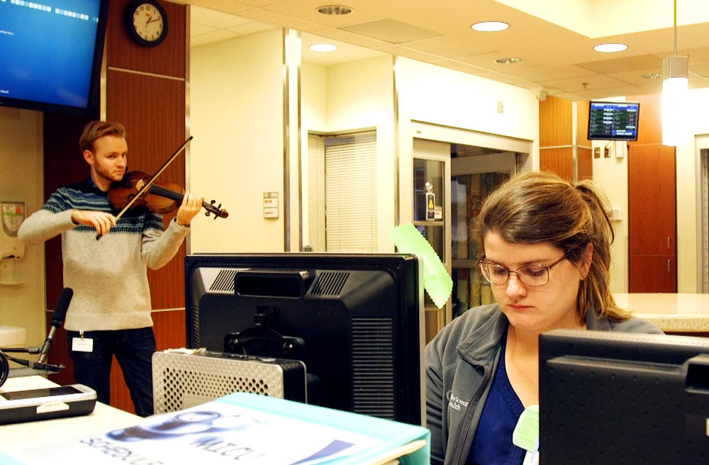 Violist Keoni Bolding performs in the Intensive Care Unit at Navicent Health in Macon recently.