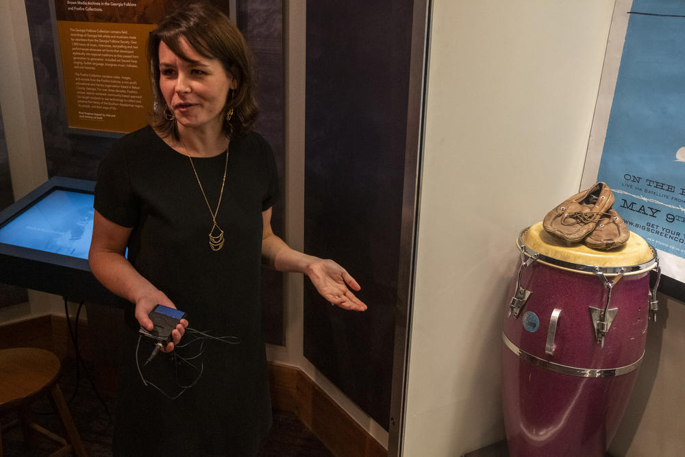 Jan Hebbard, exhibits coordinator at the Hargrett Rare Books and Manuscripts Library at UGA, with a pair of boat shoes that bleonged to John Bell of Widespread Panic. 