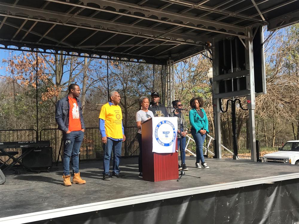 Richard Rose, president of Atlanta's NAACP chapter, is joined on stage by local social justice organizations. 