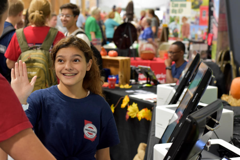 Camilla Negron, a 15-year-old student at Jenkins High School in Savannah, demonstrates the new Dominion touchscreen ballot-marking device voting machine at the Georgia National Fair in Perry.