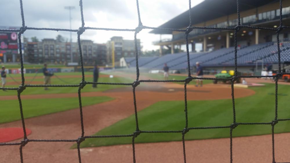 The grounds crew prepares the in-field before first pitch.