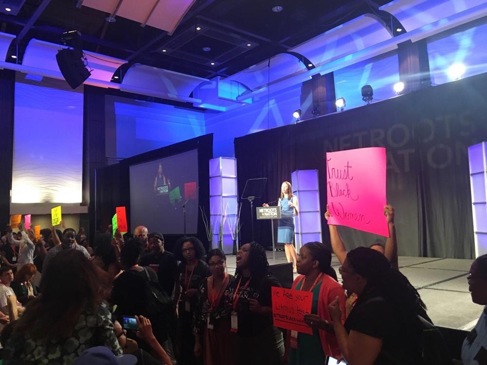 GA gubernatorial candidate Stacey Evans struggles to deliver a speech as protestors chant 