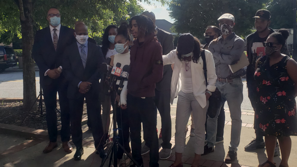 Messiah Young and Teniyah Pilgrim address the media Monday night alongside their families and their attorneys, Mawuli Davis and L. Chris Stewart.