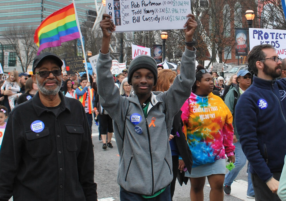 Sixteen-year-old Niles Francis, a student at South Cobb High School, marched with grandfather, Jerry Pennick. Francis is lobbying the Georgia General Assembly to pass SB 457, a school safety bill requiring more active shooter drills. 