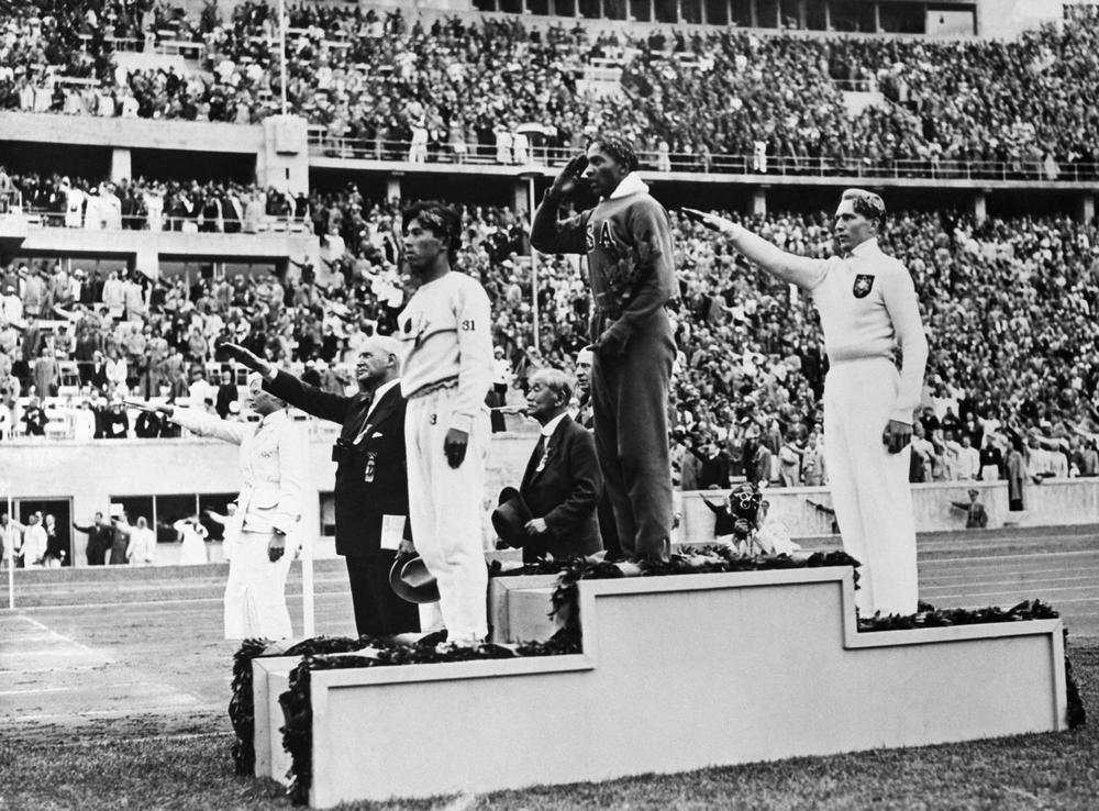 Jesse Owens on the podium after winning the long jump at the 1936 Summer Olympics in Berlin.