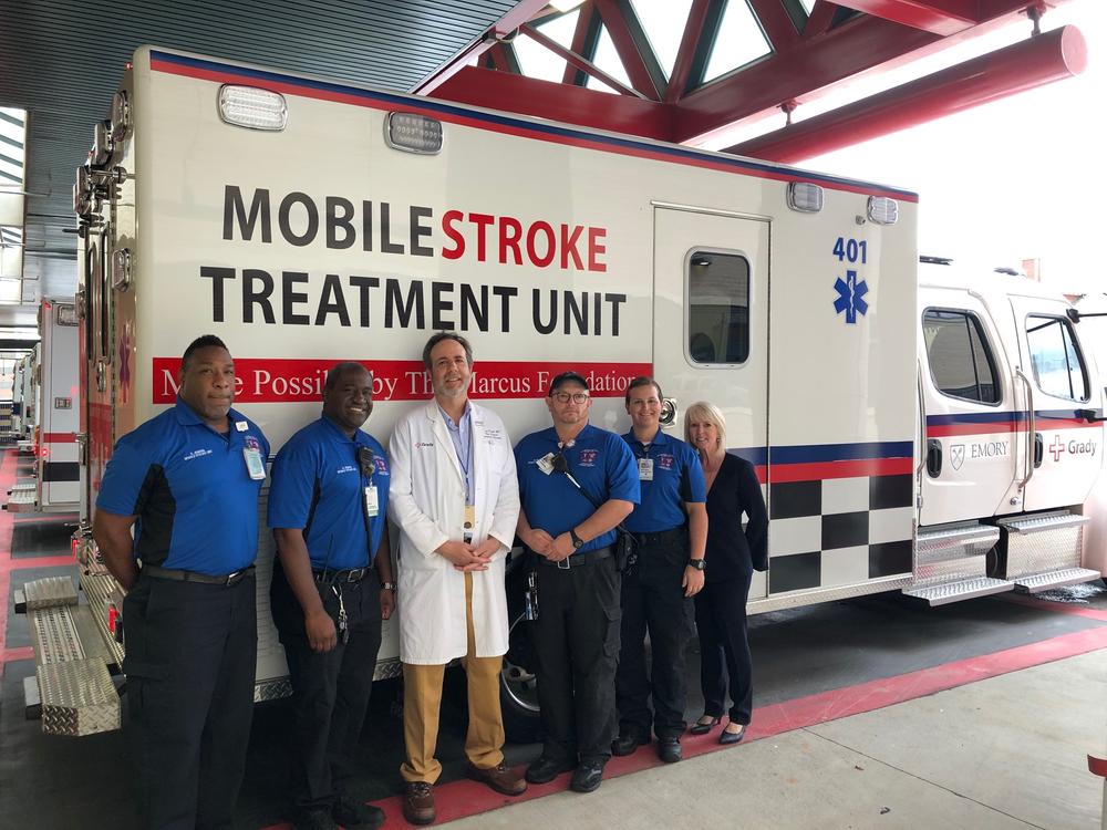 (L to R) Eric Jenkins, George Jenkins, Michael Frankel, Grady Bagley, Rebekah Nation and Carol Fleming stand by the mobile stroke ambulance at Grady Memorial Hospital.