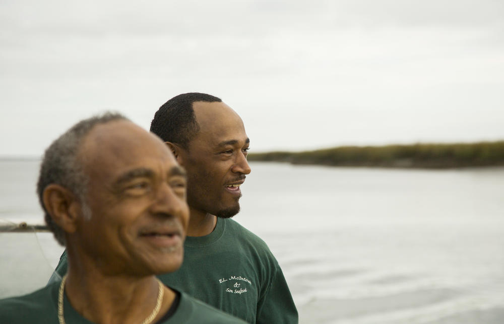 Earnest McIntosh, Jr., right, grew up watching his father, Earnest Sr., left, at work on a crab boat on the waters near their home in McIntosh County. Today they are trying to make a go of farming oysters together. 