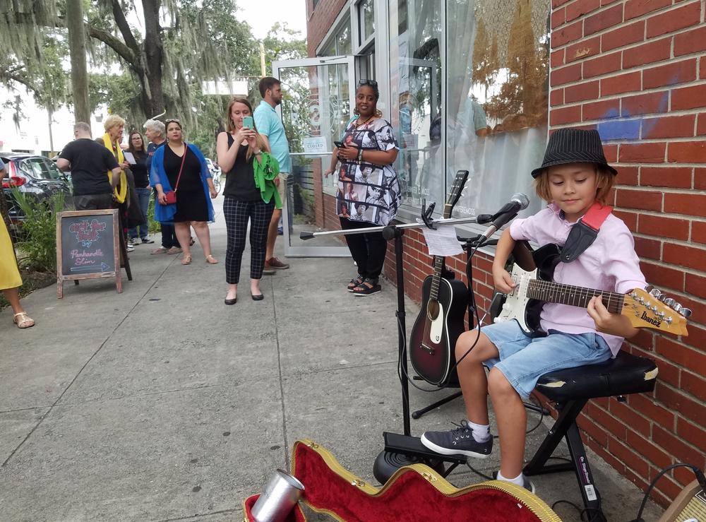 Guitarist Oz Yakabovits, 8, plays a set outside a gallery show by Savannah artist Panhandle Slim.