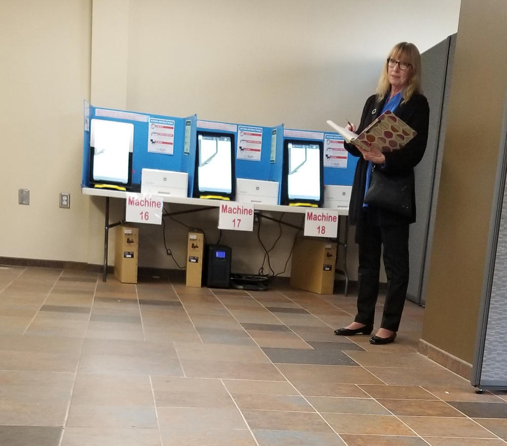 Rhonda Martin observes the pilot of Dominion ballot-marking device at a voting precinct in Paulding County on Nov. 5, 2019.
