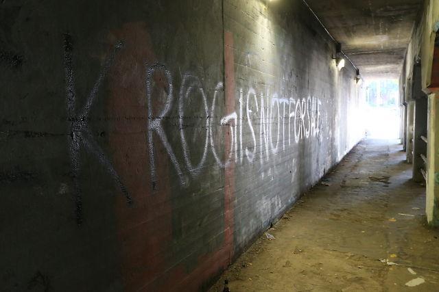 An image of the Krog Street Tunnel from the 2014 protest. The usually colorful walls of the tunnel have been painted grey, except for the message, 
