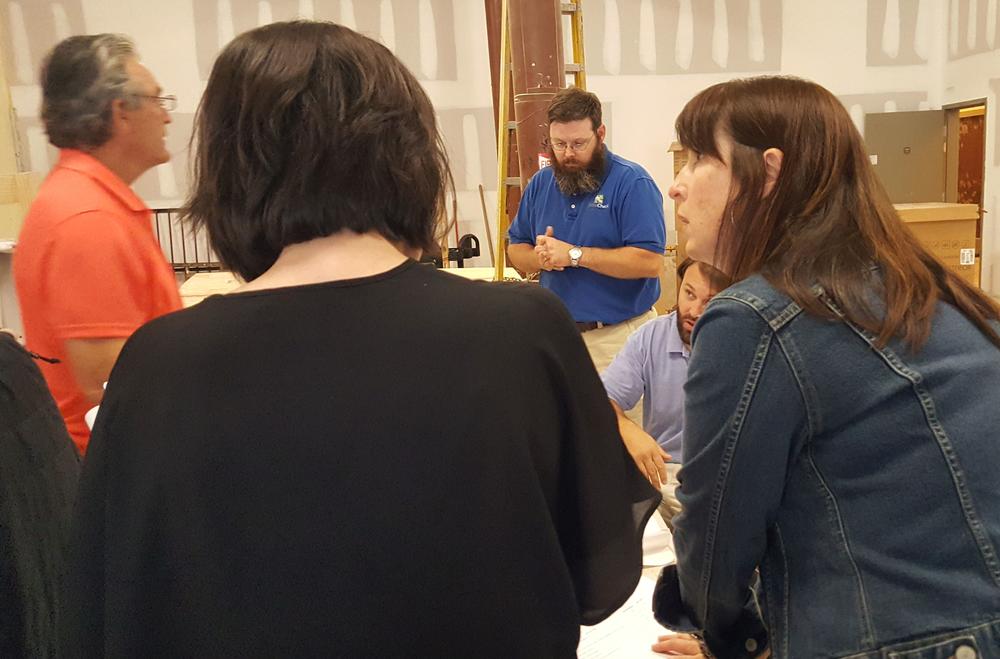 PIedmont Brewery and Kitchen co-owner Trish Whitley (in profile) in foreground. Husband and co-owner, Brian Whitley (beard and blue shirt) in background. 