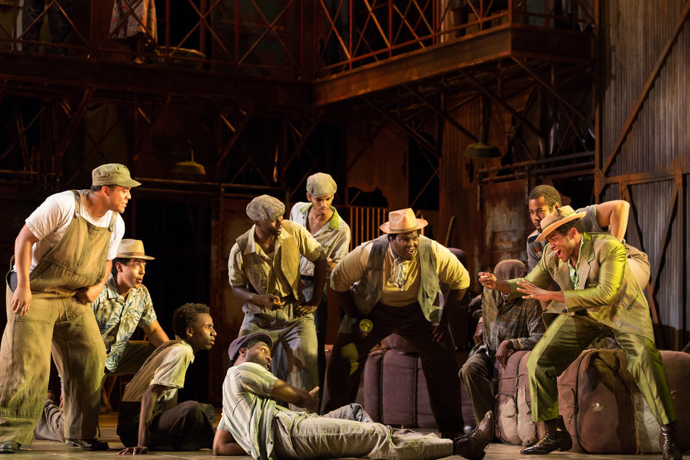 A scene fom the 2017 Glimmerglass production of 'Porgy and Bess': the men of Catfish Row gather around the craps game. The Atlanta Opera is staging 'Porgy and Bess' for five performances between Mar. 7 and 15. 