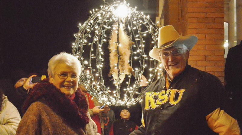 Bud and Jackie Jones pose near Spencer the stuffed opossum (in his lighted countdown ball) in Tallapoosa, Ga., in 2014.