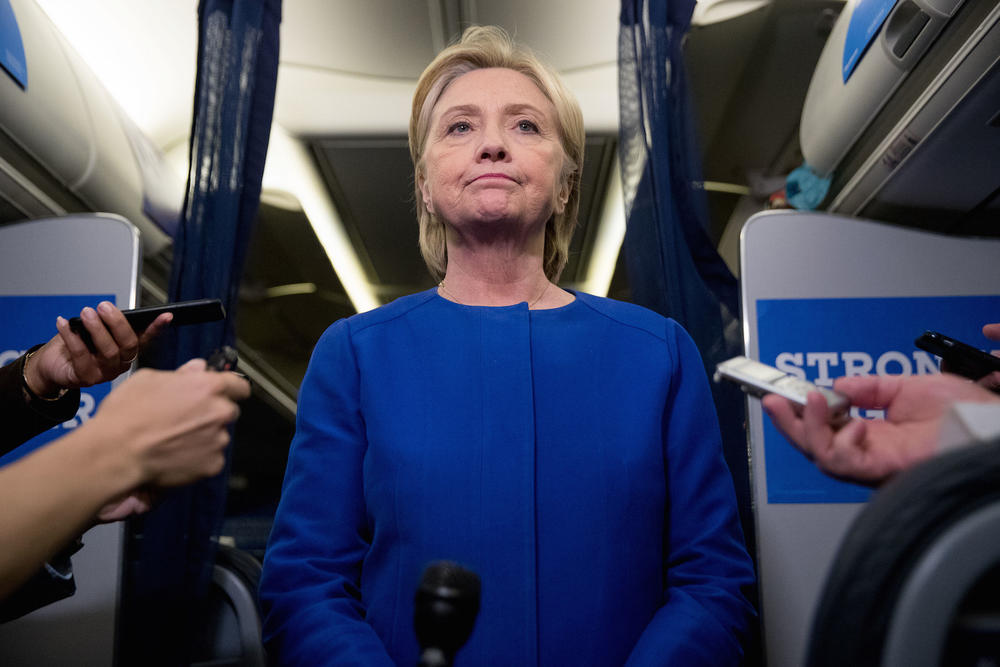 Democratic presidential candidate Hillary Clinton pauses while she gives remarks on the explosion in Manhattan's Chelsea neighborhood onboard her campaign plane at Westchester County Airport, in White Plains, N.Y., Saturday, Sept. 17, 2016. 