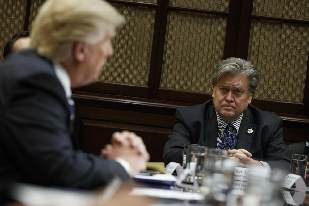 White House Chief Strategist Steve Bannon listens at right as President Donald Trump speaks during a meeting on cyber security in the Roosevelt Room of the White House in Washington, Tuesday, Jan. 31, 2017.