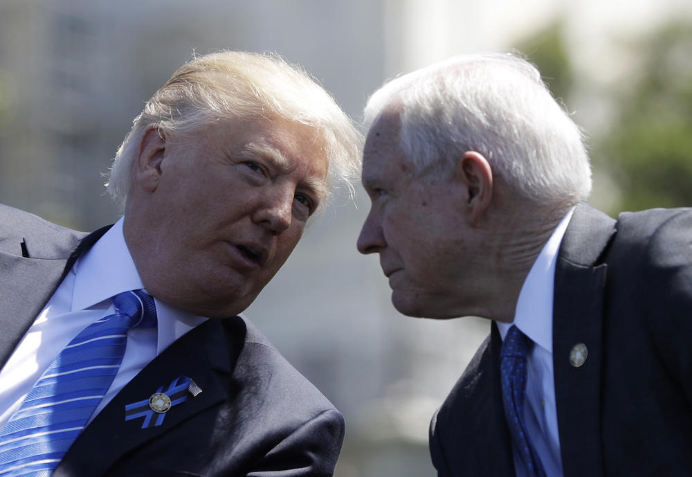 President Donald Trump talks with Attorney General Jeff Sessions, gestures before speaking at the 36th Annual National Peace Officers' memorial service, Monday, May 15. 2017, on Capitol Hill in Washington. 
