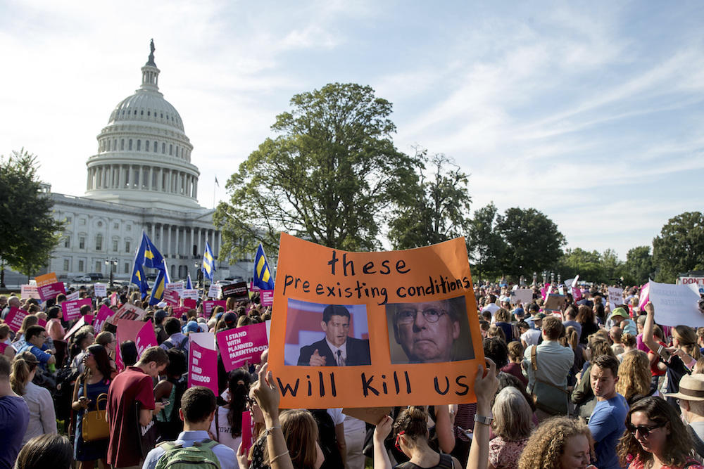 People rally against the Senate Republican health care bill on the East Front of the Capitol in Washington, Wednesday, June 28, 2017. 