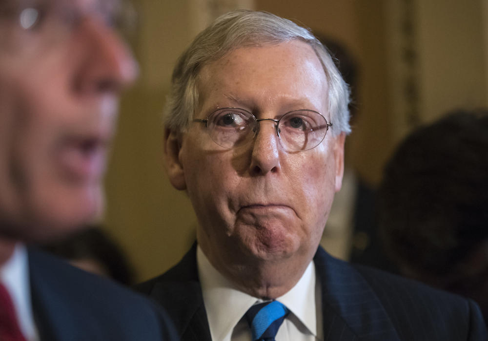 In this July 11, 2017 file photo, Senate Majority Leader Mitch McConnell of Ky. listens as Sen. John Barrasso, R-Wyo. speaks during a news conference on Capitol Hill in Washington.