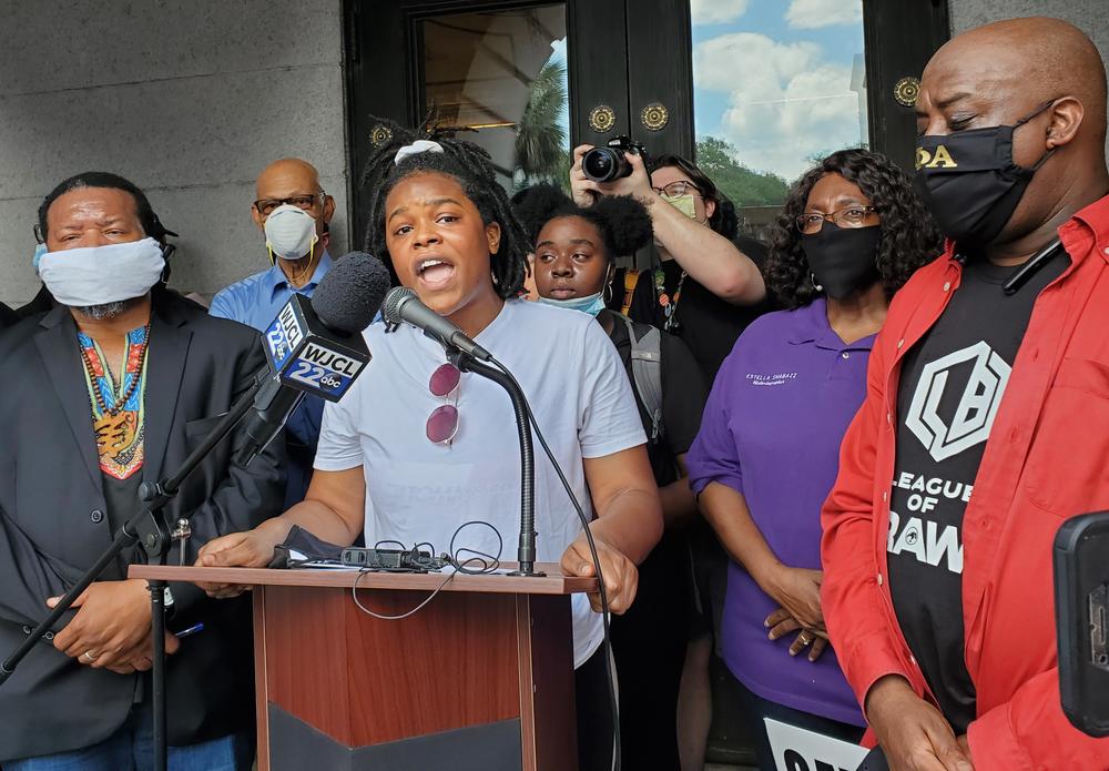 Activist Faith Harris addresses a crowd of hundreds of protesters in Savannah, surrounded by (left to right) Francys Johnson of the New Georgia Project, former Savannah Mayor Otis Johnson, activist Nychorida Austin, Alderwoman Estella Shabazz, and current Savannah Mayor Van Johnson.