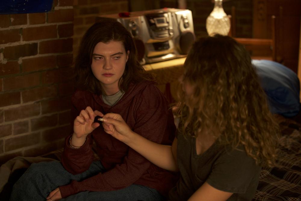 Actors playing Holly and Sandy recreate smoking marijuana. 