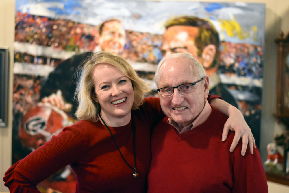 GPB's Rickey Bevington and former UGA coach Vince Dooley stand in his Athens, Ga. home during a tour of his favorite memorabilia from the 1980 national championship season.