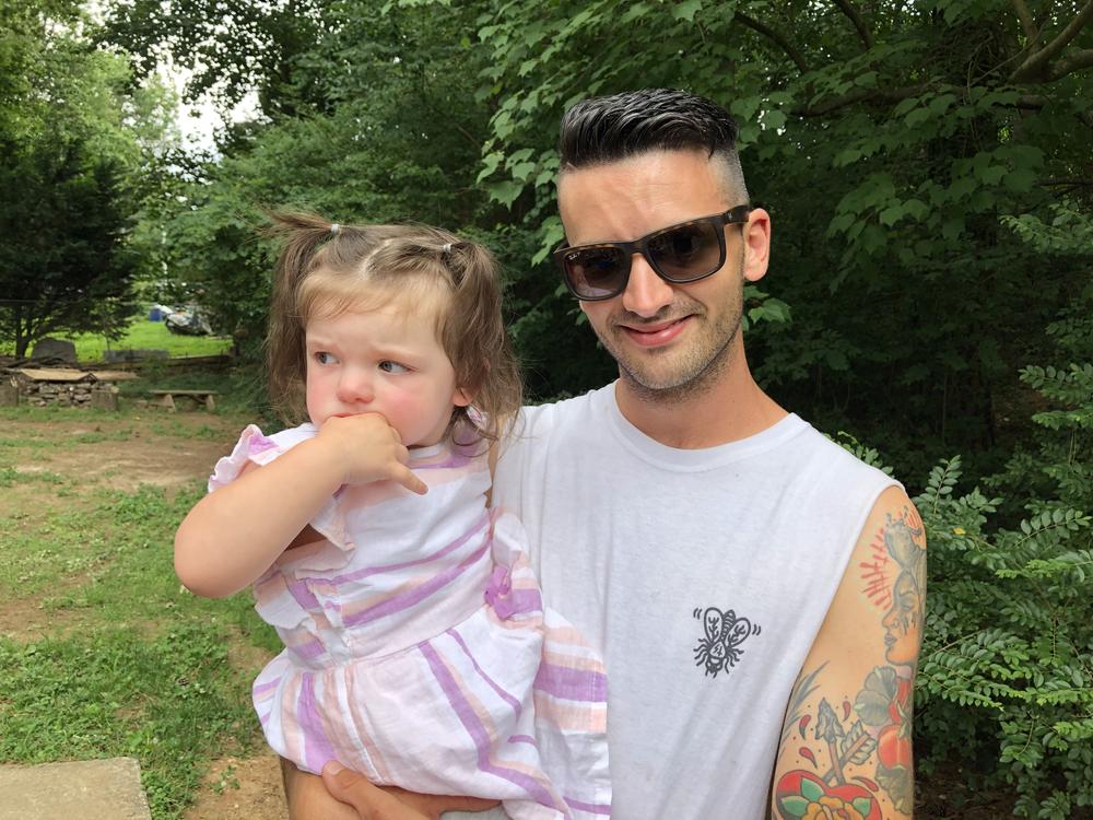 Rob Petrecca holds his 2-year-old daughter. Petrecca has been in recovery from substance use disorder since February 2018.
