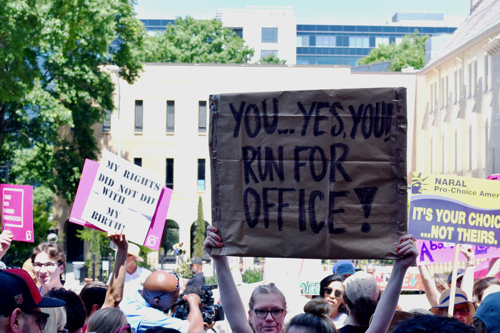 Abortion rights supporters hold signs at a rally at the Georgia State Capitol Tuesday, May 21, 2019.