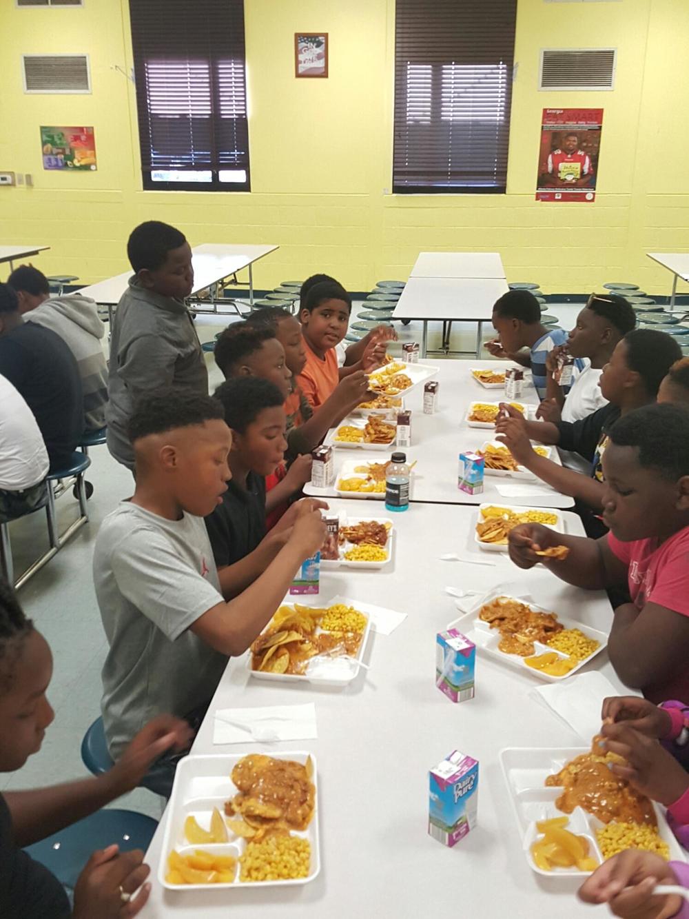 Children eat at the Reconstructing Youth Foundation in Tyrone, Georgia. 