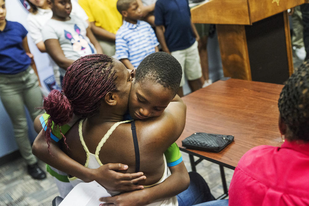 A boy is reunited with his mother at the end of the 